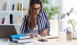 Woman writing at a desk