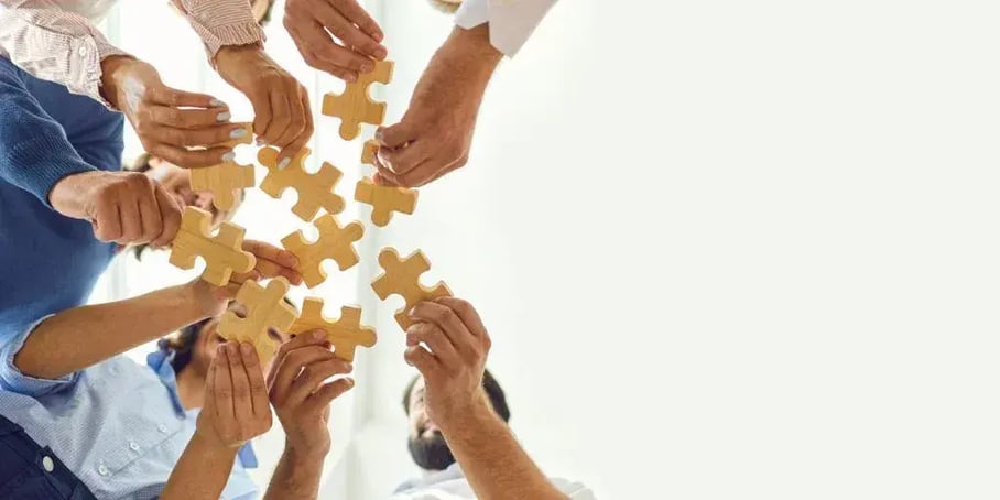 People holding puzzle pieces