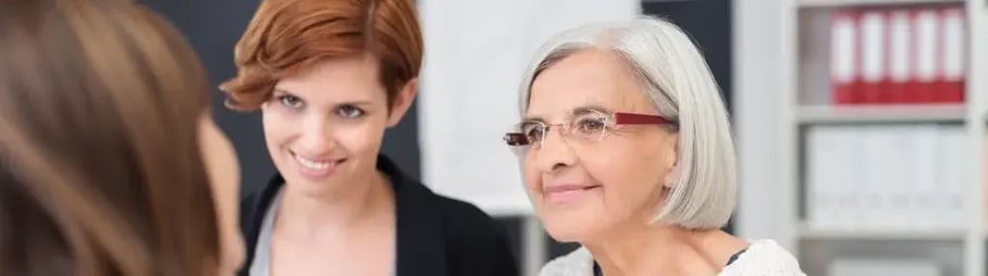 Older and yonger woman smiling