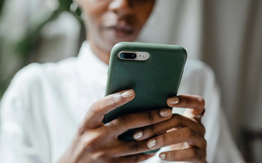 A woman holding a turquoise smartphone
